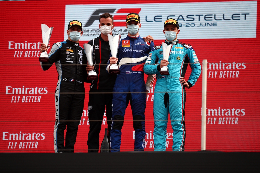 Calan Williams standing on the podium after completing his race