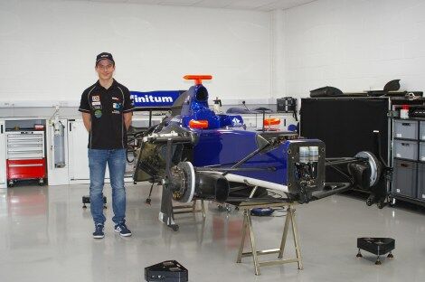 Calan Williams standing next to his car